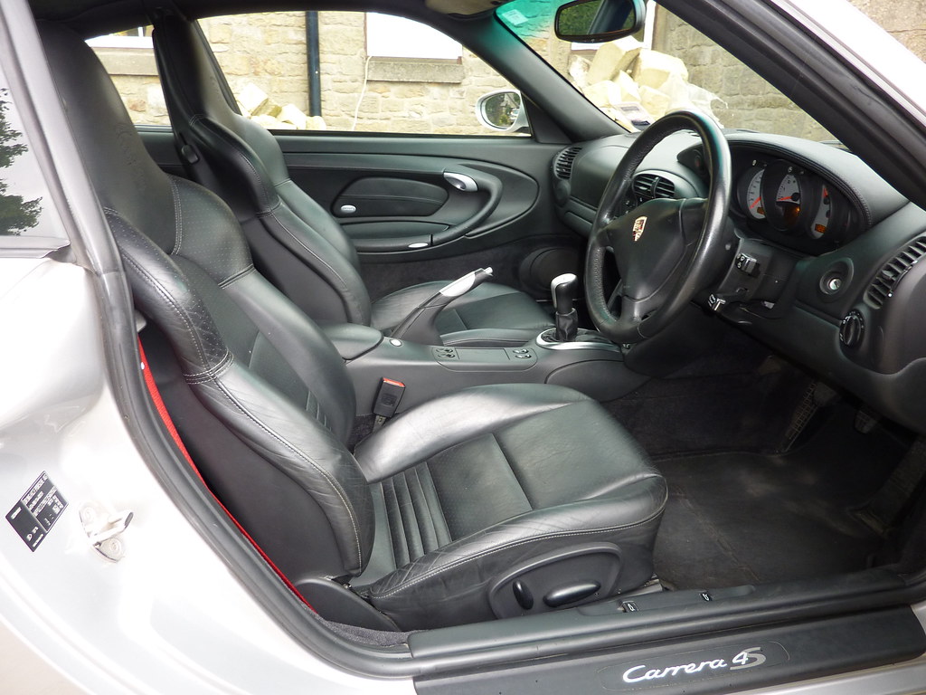 The same interior with clean rich black leather after deep interior detailing