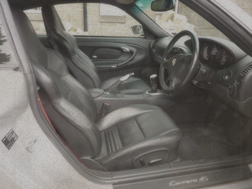Dingy dull car interior with dirty leather seats and carpets before detailing